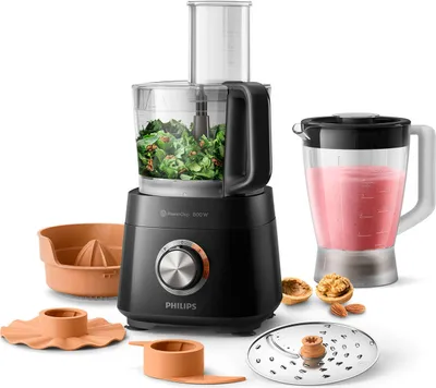A black Philips food processor with various attachments and a blender jar filled with pink liquid, displayed on a white background.