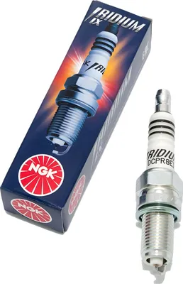 A product shot of a spark plug and its packaging.