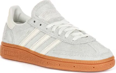 A single Adidas Handball Spezial shoe in grey with white stripes and a gum sole, shown from a side angle against a white background.