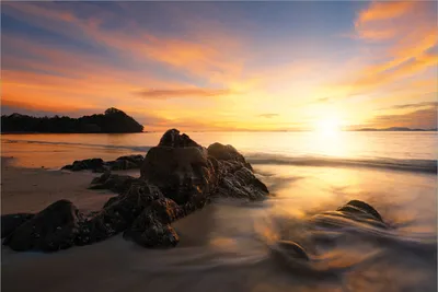 Produktbild von Wallario Premium Vliestapete Fototapete Sonne über dem Meer mit Felsenlandschaft in der Größe 400 x 267 cm, extra dick, wird in 5 Teilen geliefert