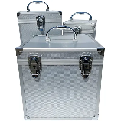 Three silver aluminum cases of varying sizes are arranged diagonally on a white background.