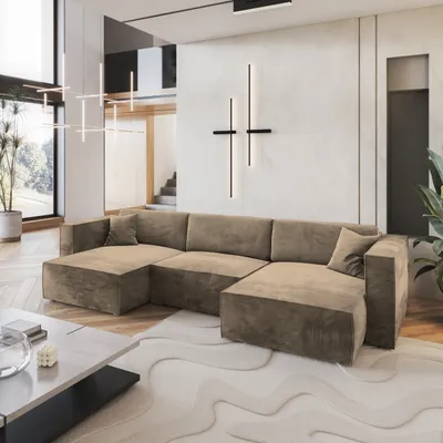 A modern living room with a large sectional sofa, coffee table, and abstract wall art.