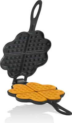 A black cast iron waffle maker in the shape of a four-leaf clover, open to reveal four heart-shaped waffles.