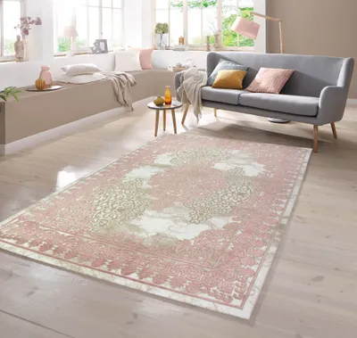 A living room scene with a sofa, rug, and seating area.