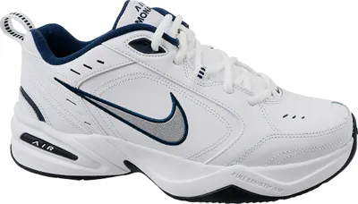 A white Nike Air Monarch IV sneaker with navy blue accents.