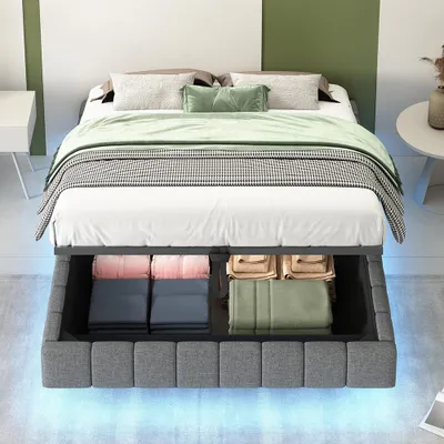 A bed with storage underneath, shown in a bedroom setting with decorative pillows and blankets.