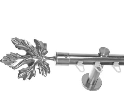 A close-up view of a curtain rod with a decorative leaf finial.