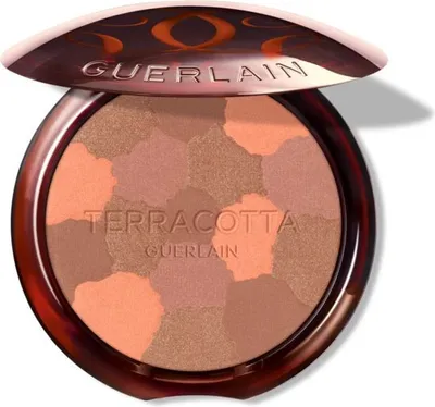 A Guerlain Terracotta Light bronzer compact with the lid open, showing the multi-colored powder inside.