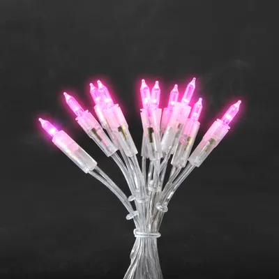 A bunch of pink LED lights tied together against a black background.