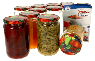 A collection of glass jars filled with preserved food items, arranged on a white background.