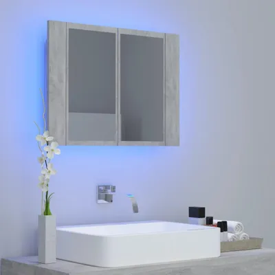 A modern bathroom vanity with a sink, faucet, and a medicine cabinet with LED lighting.