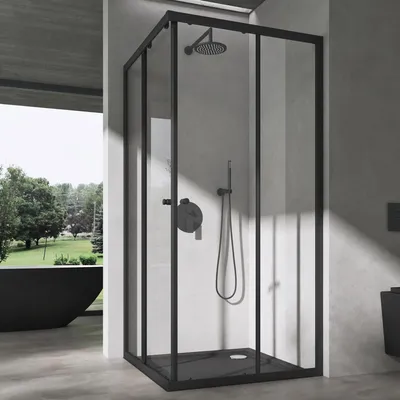 A modern bathroom with a black framed glass shower enclosure.