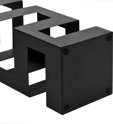 A black metal geometric shelf or stand.