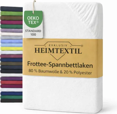 A white fitted sheet is shown, with a stack of other colored sheets to the left. A product tag is attached to the sheet.