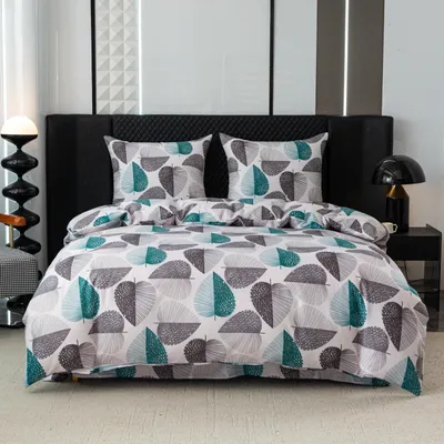 A neatly made bed with a duvet cover and pillows, featuring a leaf pattern, in a bedroom setting.