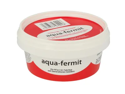 A white plastic tub with a red lid containing a sealant product.