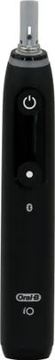 A black electric toothbrush is shown against a white background.