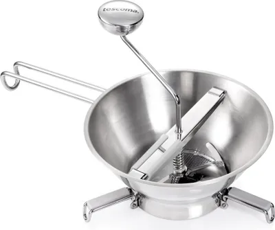 A stainless steel food mill with a handle and a plunger.