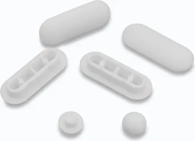 A collection of white toilet seat buffers and stoppers on a white background.