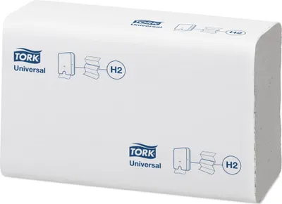 A stack of white TORK Universal paper towels, showing diagrams of dispenser use.