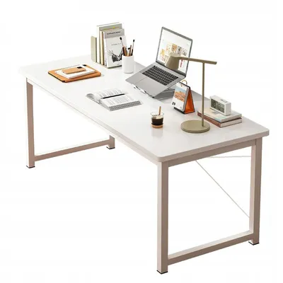 A white computer desk with various office supplies on it, including a laptop, books, a lamp, and a cup of coffee.