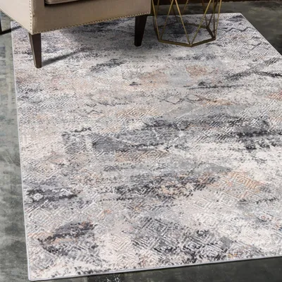 A rug is shown under a chair and next to a small table.