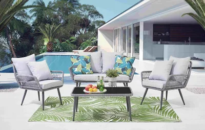 An outdoor patio scene with a seating set by a swimming pool.