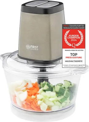 A food chopper with chopped vegetables in its container, along with marketing badges.