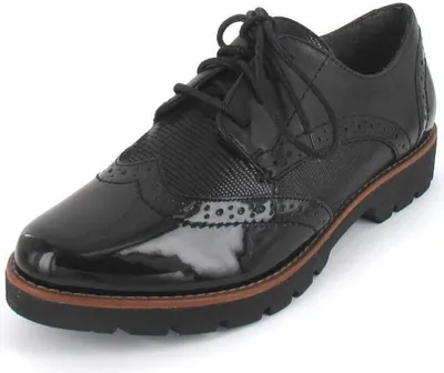 A black leather lace-up shoe with wingtip detailing and a thick sole, shown from a side-front angle on a white background.