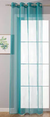 A sheer turquoise curtain hangs in front of a window with a grid pattern.