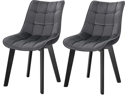Two dark gray velvet chairs with black wooden legs are shown against a white background.