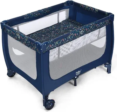 A blue baby travel cot with a patterned mattress and lining, shown from a diagonal angle.