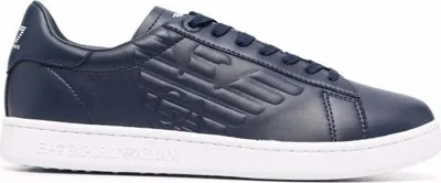 A close-up side view of a blue sneaker with a white sole.