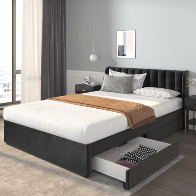 A bedroom scene featuring a bed with storage drawers.