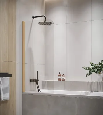 A modern bathroom with a bathtub and shower screen.