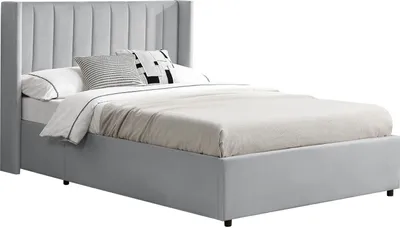 A light gray upholstered bed with a tall, tufted headboard and a storage base, shown with white and patterned pillows and bedding.