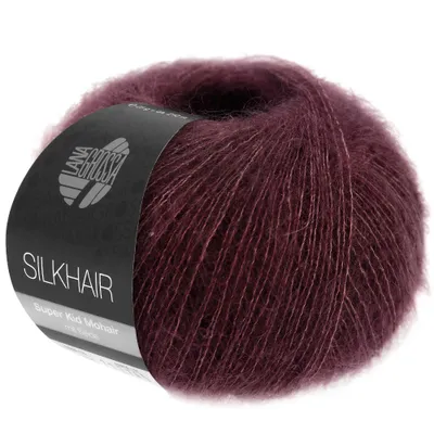 A ball of dark red yarn with a label.