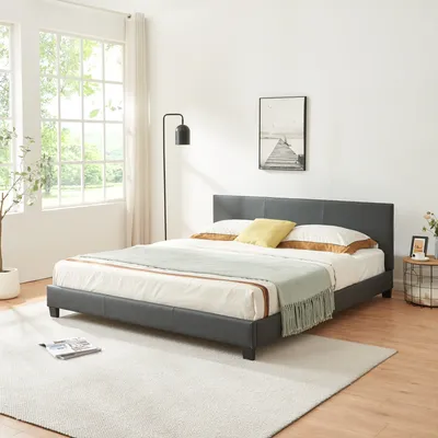 A bedroom scene with a bed, lamp, and window.
