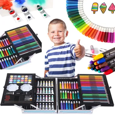 A young boy giving a thumbs up next to various art supplies.