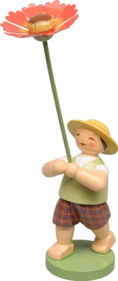 A wooden figurine of a boy holding a large orange flower.