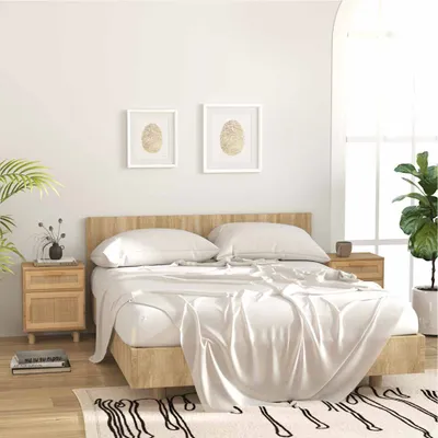 A bedroom scene with a bed, nightstands, and plants.