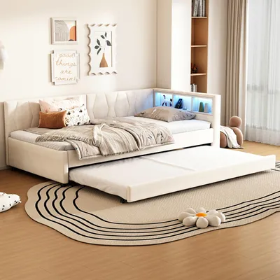 A bedroom scene featuring a beige linen daybed with a pull-out trundle bed.