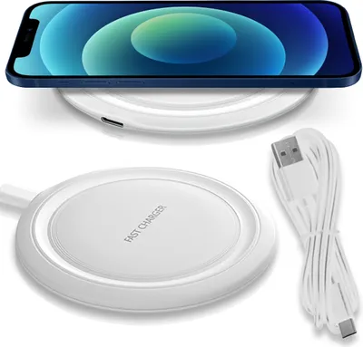 A smartphone is placed on a wireless charger, with a separate wireless charger and USB cable shown.