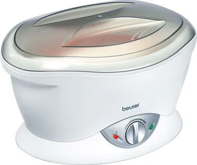 A white Beurer paraffin bath with a silver lid sits on a white base.