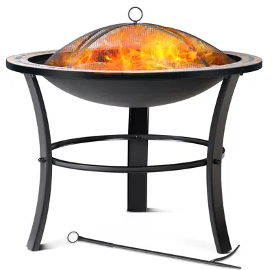 A black metal fire pit with a mesh cover and flames inside, resting on a white background. A fire poker tool is placed in front of the fire pit.