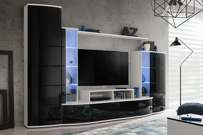 A modern living room wall unit with a TV, shelves, and cabinets.