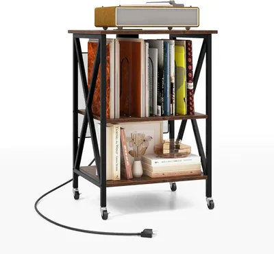 A rolling cart filled with books and decorative items, topped with a record player.