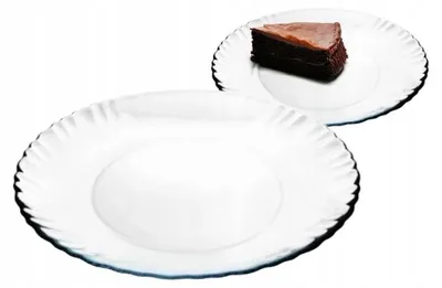 Two white dessert plates, one with a slice of chocolate cake on it, against a white background.