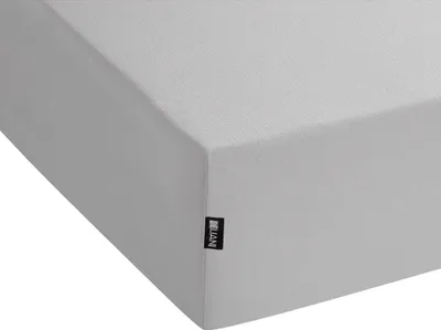 A close-up view of a light gray fitted sheet, showing the corner and a small black label with white text.
