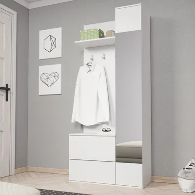 A white wardrobe set with a mirror, coat hooks, and drawers, set against a light gray wall.